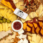 Assorted cheeses, fruits, and nuts on a platter with a 'Lea & Co.' logo.