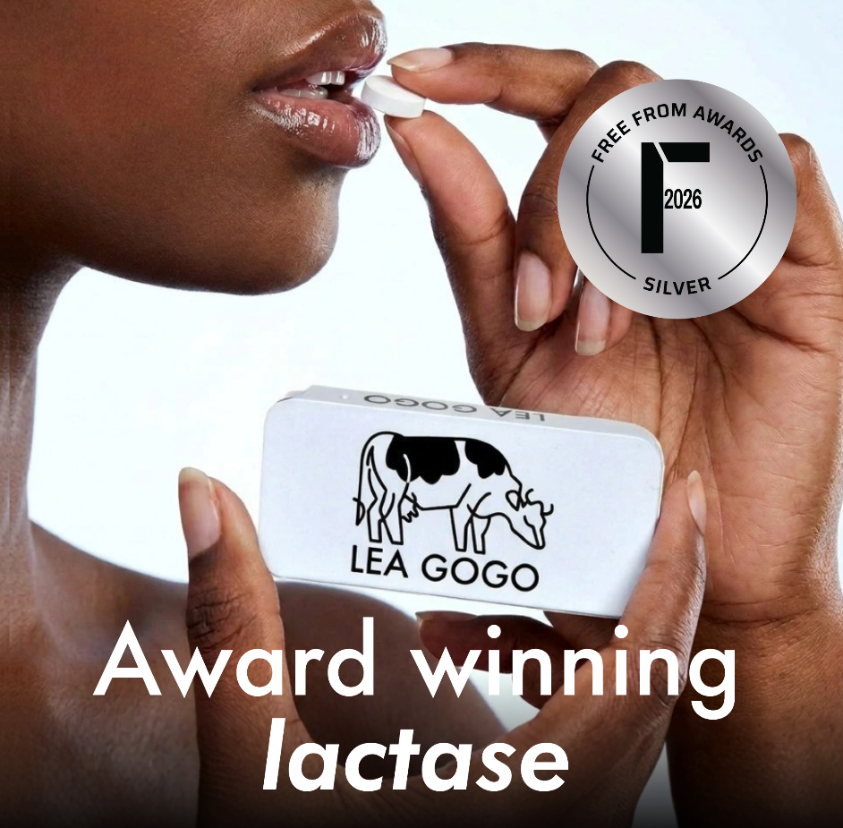 A close-up of a person holding a white LEA GOGO lactase tablet near their mouth, with a silver award badge reading 'Free From Awards Silver 2026' and the text 'Award winning lactase' on a white background.